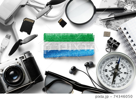 Flag of Sierra Leone and travel accessories on a white background. 74346050