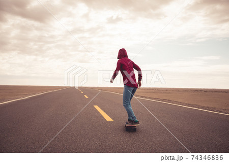 Asian woman skateboarder skateboarding in the wide world 74346836