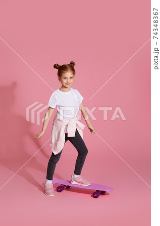 Stylish little child girl with skateboard 74348367