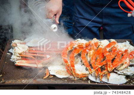 Tokyo, Japan Street in Tsukiji outer market in Ginza with closeup retail sample display of cooked red crab lobster legs white meat. Tokyo, Japan Street in Tsukiji outer market in Ginza with closeup retail sample display of cooked red crab lobster legs white meat. 74348428