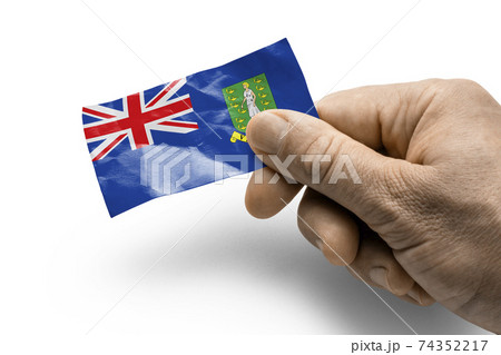 Hand holding a card with a national flag the British Virgin Islands Hand holding a card with a national flag the British Virgin Islands 74352217