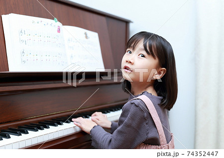 アップライトピアノを弾く5歳の女の子 74352447