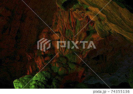 Stalactite and stalagmite formations in a limestone cave of Halong Bay, 74355136