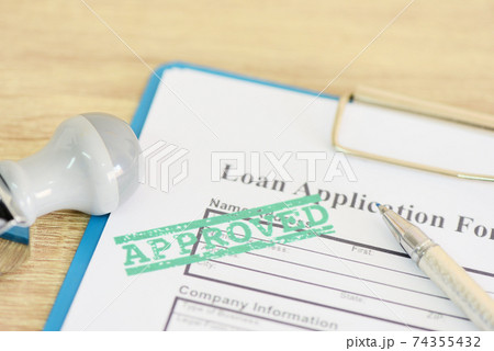 Loan approval, Loan application form with Rubber stamping that says Loan Approved, Financial loan money contract agreement company credit or person. 74355432