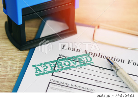 Loan approval, Loan application form with Rubber stamping that says Loan Approved, Financial loan money contract agreement company credit or person. 74355433