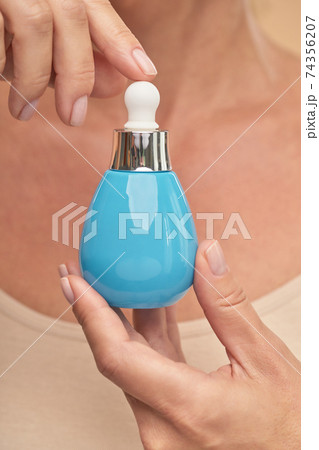 Close up of lady showing a jar of cosmetic product 74356207