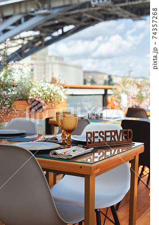 Reserved table sign in a restaurant on summer terrace Reserved table sign in a restaurant on summer terrace 74357268