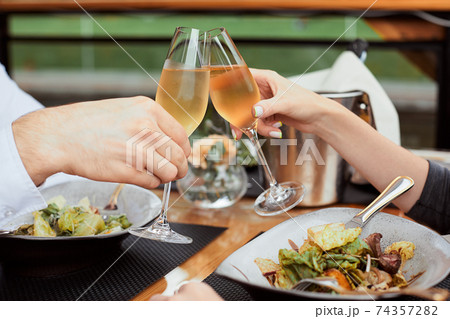 couple having amazing lunch and drink champagne at outdoor restaurant couple having amazing lunch and drink champagne at outdoor restaurant 74357282