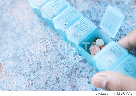 close up of pills and capsule in a pill box close up of pills and capsule in a pill box 74360776