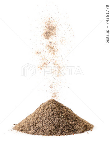 Black ground pepper is poured on a pile on a white background. Isolated Black ground pepper is poured on a pile on a white background. Isolated 74361779