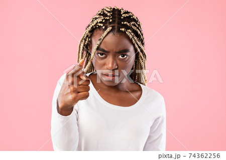 Angry afro woman pointing finger at camera 74362256