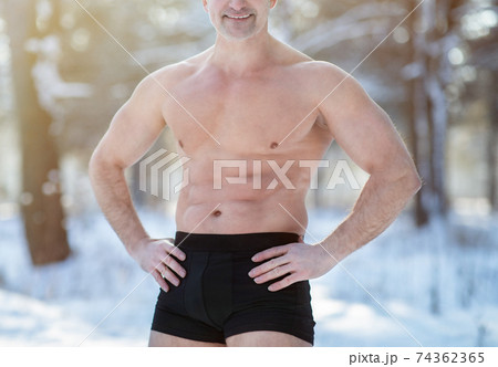 Cold resistance training concept. Unrecognizable senior man with naked torso posing in his underwear at winter park 74362365