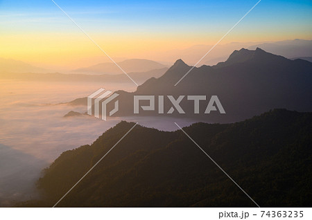 Beautiful misty mountain range in Laos from Phu Chi Fa mountain viewpoint in Chiang Rai 74363235