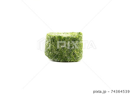 Pressed frozen spinach isolated on a white background. 74364539