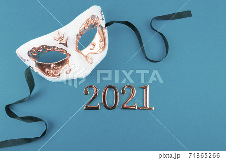 New Year carnival mask on blue background. 74365266