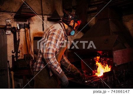 Fire of blacksmith in the blacksmith's workshop. Fire of blacksmith in the blacksmith's workshop. 74366147
