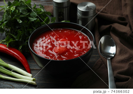 Concept of tasty food with borscht and ingredients on wooden background 74366302