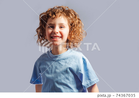 little girl jumps on a gray background 74367035