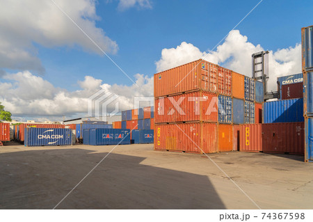 Shipping container site loading by crane in logistic port warehouse storage factory manufacturing business transportation import and export goods of freight business carrier. 74367598