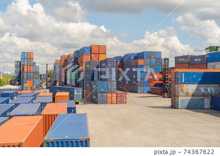 Shipping container site loading by crane in logistic port warehouse storage factory manufacturing business transportation import and export goods of freight business carrier. 74367622