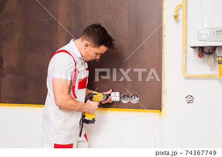The electrician is happy to work at the new object 74367749