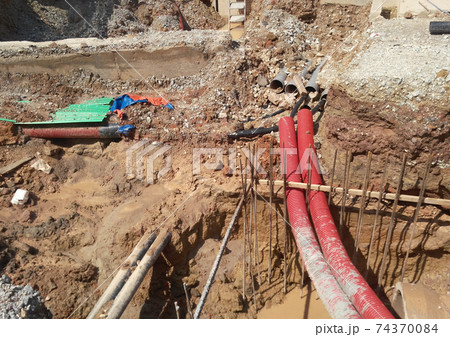 SEREMBAN, MALAYSIA -MARCH 02, 2017: Underground utility and services corrugated pipe lay by workers at the construction site. The corrugated pipe used to protect cable lay inside it. SEREMBAN, MALAYSIA -MARCH 02, 2017: Underground utility and services corrugated pipe lay by workers at the construction site. The corrugated pipe used to protect cable lay inside it. 74370084