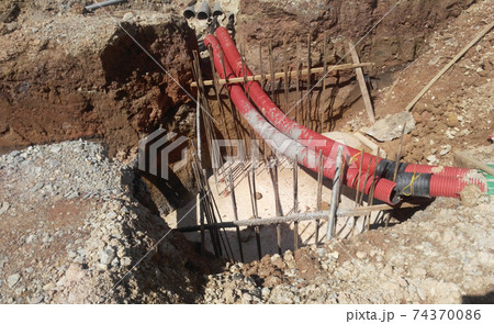 SEREMBAN, MALAYSIA -MARCH 02, 2017: Underground utility and services corrugated pipe lay by workers at the construction site. The corrugated pipe used to protect cable lay inside it. SEREMBAN, MALAYSIA -MARCH 02, 2017: Underground utility and services corrugated pipe lay by workers at the construction site. The corrugated pipe used to protect cable lay inside it. 74370086