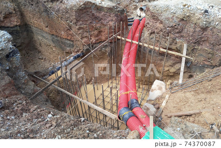 SEREMBAN, MALAYSIA -MARCH 02, 2017: Underground utility and services corrugated pipe lay by workers at the construction site. The corrugated  pipe used to protect cable lay inside it.   74370087