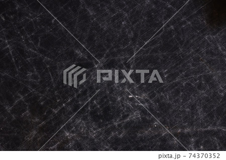 The texture of scratches on fabric on a black background 74370352
