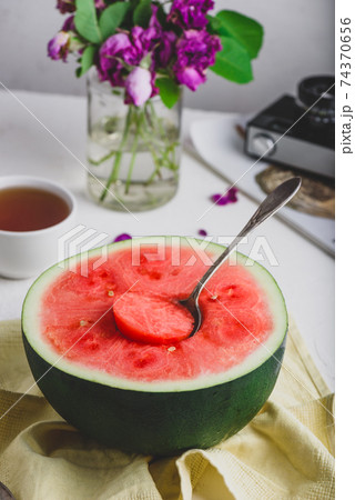 The Spoon in the Ripe Red Watermelon The Spoon in the Ripe Red Watermelon 74370656