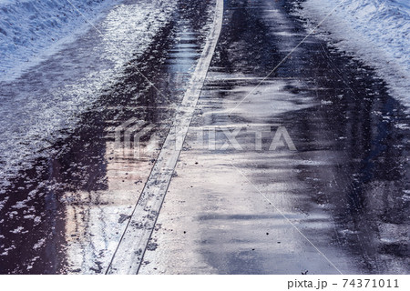 Wet asphalt road surface. 74371011