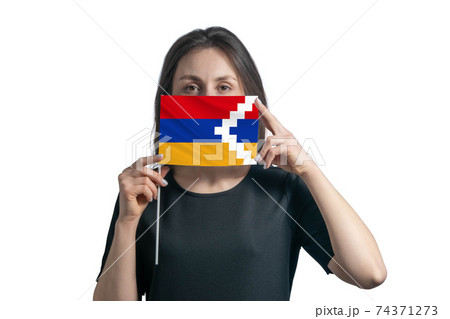 Happy young white woman holding flag Nagorno-Karabakh Republic flag and covers her face with it isolated on a white background Happy young white woman holding flag Nagorno-Karabakh Republic flag and covers her face with it isolated on a white background 74371273