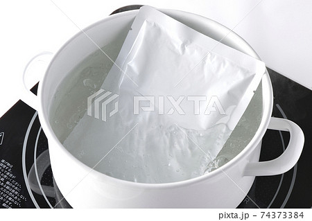 IHクッキングヒーターを使いレトルトパックを白い鍋で温める 74373384