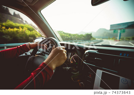 Driving car on a fork in the highway road 74373643