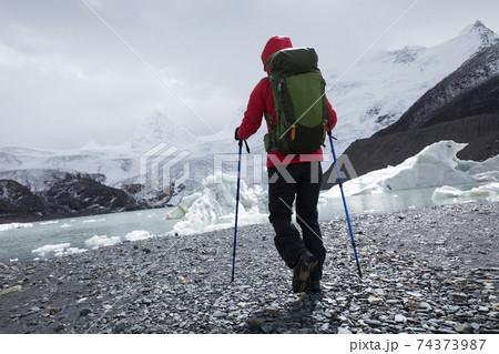 Woman hiker hiking in winter mountains Woman hiker hiking in winter mountains 74373987