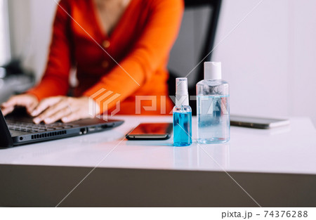 Sanitizer gel in spray bottle and hand sanitizer gel for coronavirus protection,Working at home,Work from home concept 74376288