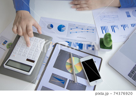 Financial businessman calculating corporate income tax data And analyzing charts of financial stocks that are in good condition with growth and progress, Investment in finance and accounting. 74376920