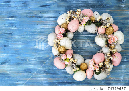 Easter wreath of colorful decorative eggs, flowers Easter wreath of colorful decorative eggs, flowers 74379687