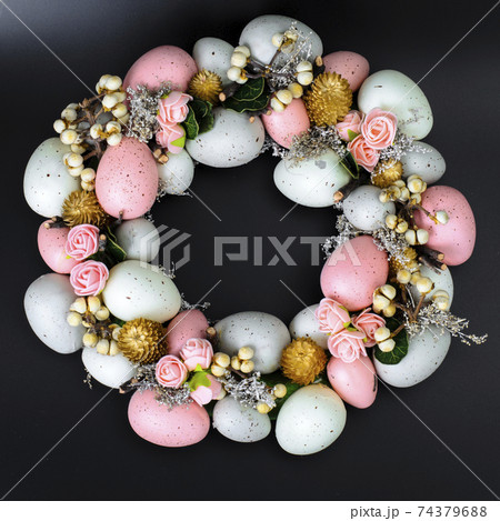 Easter wreath of colorful decorative eggs, flowers Easter wreath of colorful decorative eggs, flowers 74379688