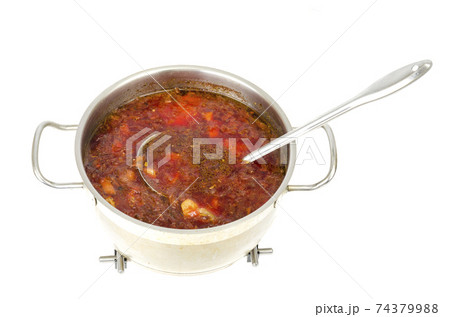 Saucepan with vegetable beetroot soup on white background. 74379988
