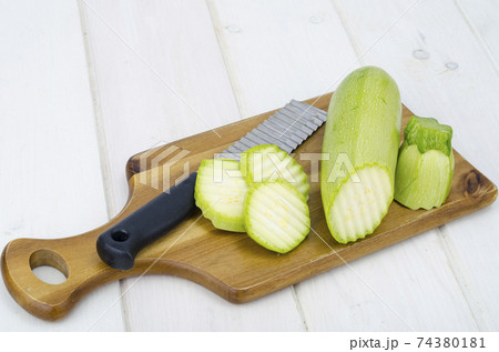 Green young fresh zucchini on wooden table for cooking 74380181