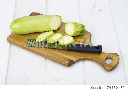 Green young fresh zucchini on wooden table for cooking Green young fresh zucchini on wooden table for cooking 74380182