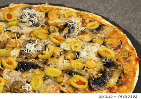 Pizza with mussels, mushrooms, green olives Pizza with mussels, mushrooms, green olives 74380192