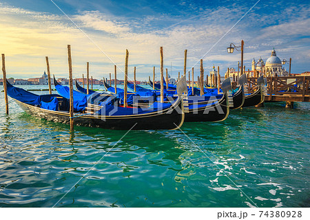 Moored gondolas at sunrise by Saint Mark square, Venice, Italy Moored gondolas at sunrise by Saint Mark square, Venice, Italy 74380928