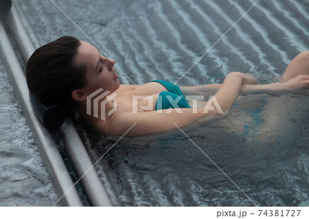 Seductive female resting in pool Seductive female resting in pool 74381727