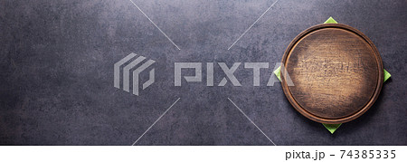 Pizza or bread cutting board for homemade baking on table. Food recipe concept Pizza or bread cutting board for homemade baking on table. Food recipe concept 74385335