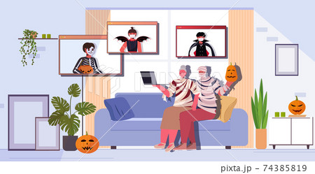 happy halloween holiday celebration grandparents in mummy costumes discussing with children during video call happy halloween holiday celebration grandparents in mummy costumes discussing with children during video call 74385819
