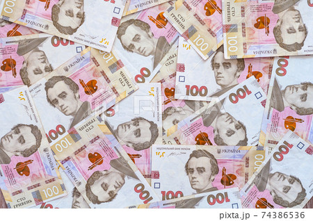 Paper money, Ukrainian hryvnia in denomination 100 hryvnia, new money, background with scattered banknotes Paper money, Ukrainian hryvnia in denomination 100 hryvnia, new money, background with scattered banknotes 74386536