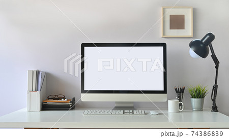 Photo of white blank screen computer  and office equipment is on the table. Modern working desk concept. 74386839