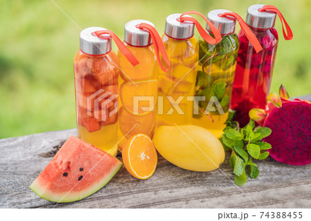 Cambucha with various fruits arranged in the form of a rainbow. Homemade fermented raw kombucha tea with different flavorings. Healthy natural probiotic flavored drink. LGBT 74388455